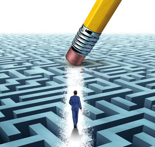 Stock photo leadership solutions with a businessman walking through a complicated maze opened up by a pencil 129998429